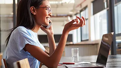 Reaching the Millennial Consumer A young woman talking on the phone at her desk